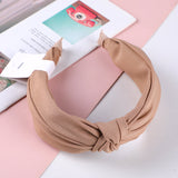 Cerchietto per capelli con nodo centrale in tessuto monocromatico