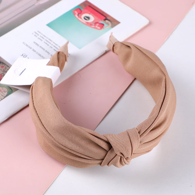 Cerchietto per capelli con nodo centrale in tessuto monocromatico