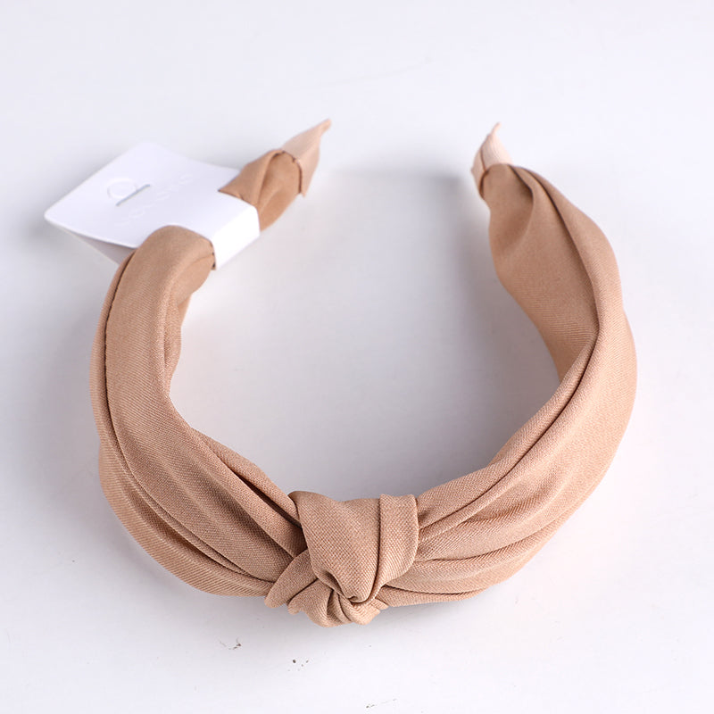 Cerchietto per capelli con nodo centrale in tessuto monocromatico