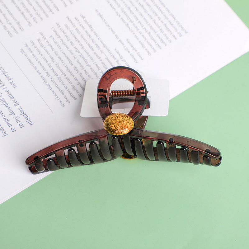 Fermaglio per capelli in acrilico incrociato con toppa rotonda