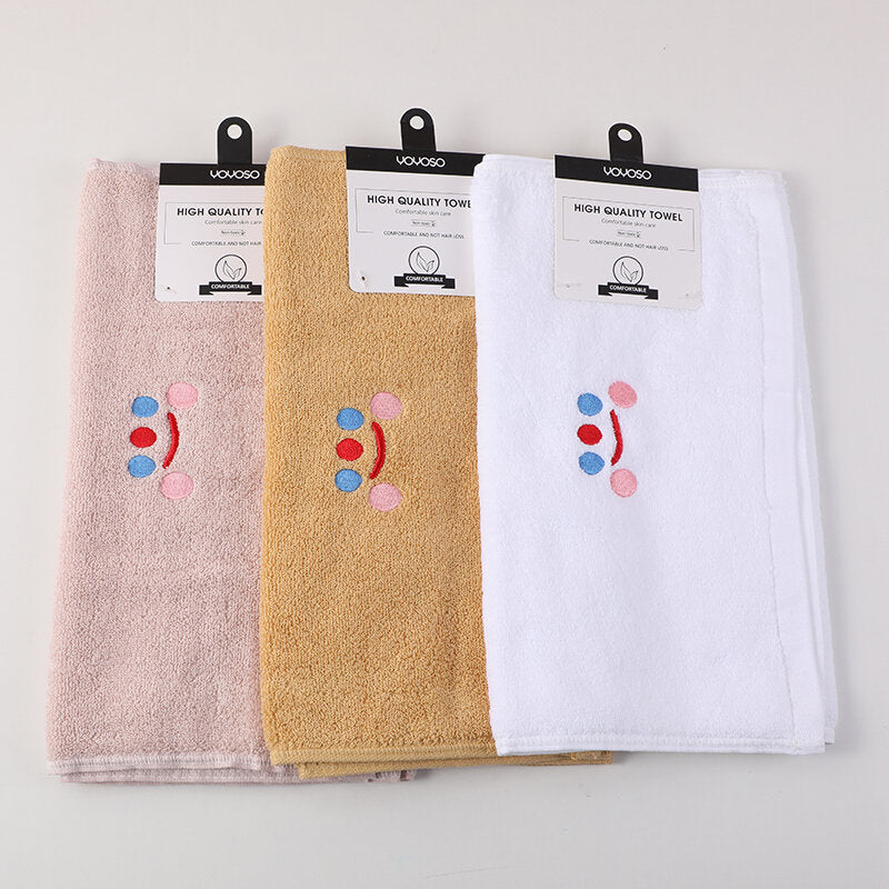 Asciugamano in puro cotone con ricamo del volto sorridente