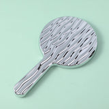 Specchio di bellezza rotondo ondulato con maniglia