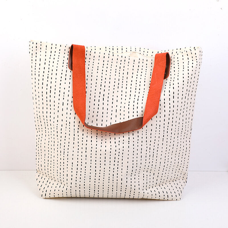 Semplice shopping bag geometrica con tracolla in pelle