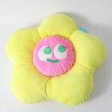 Cuscino a forma di fiore con faccina sorridente colorata, giallo