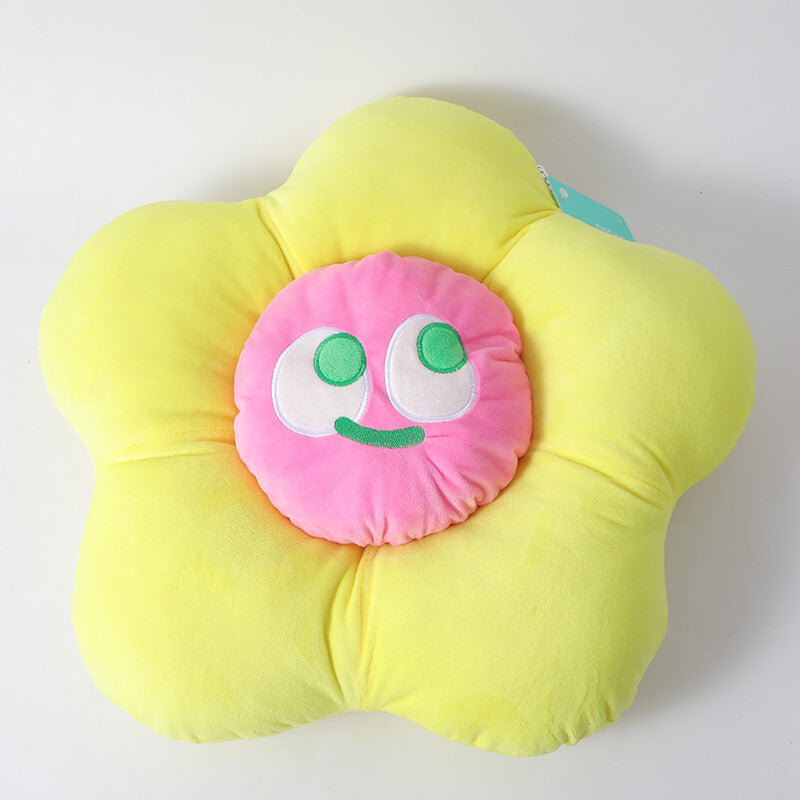 Cuscino a forma di fiore con faccina sorridente colorata, giallo