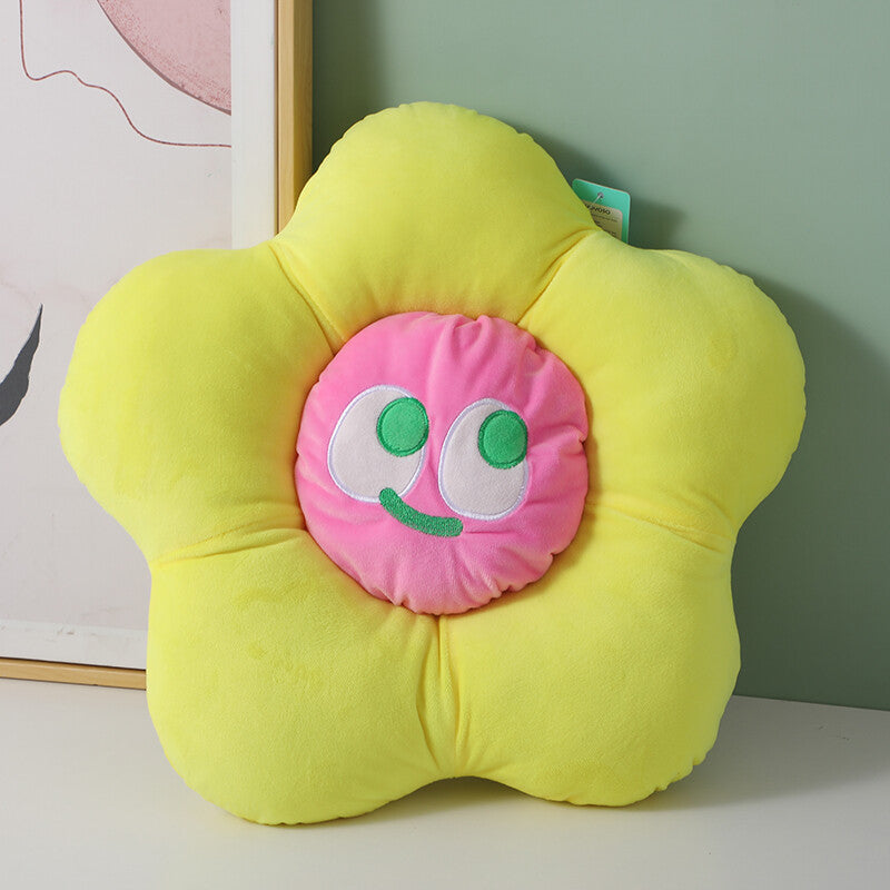 Cuscino a forma di fiore con faccina sorridente colorata, giallo