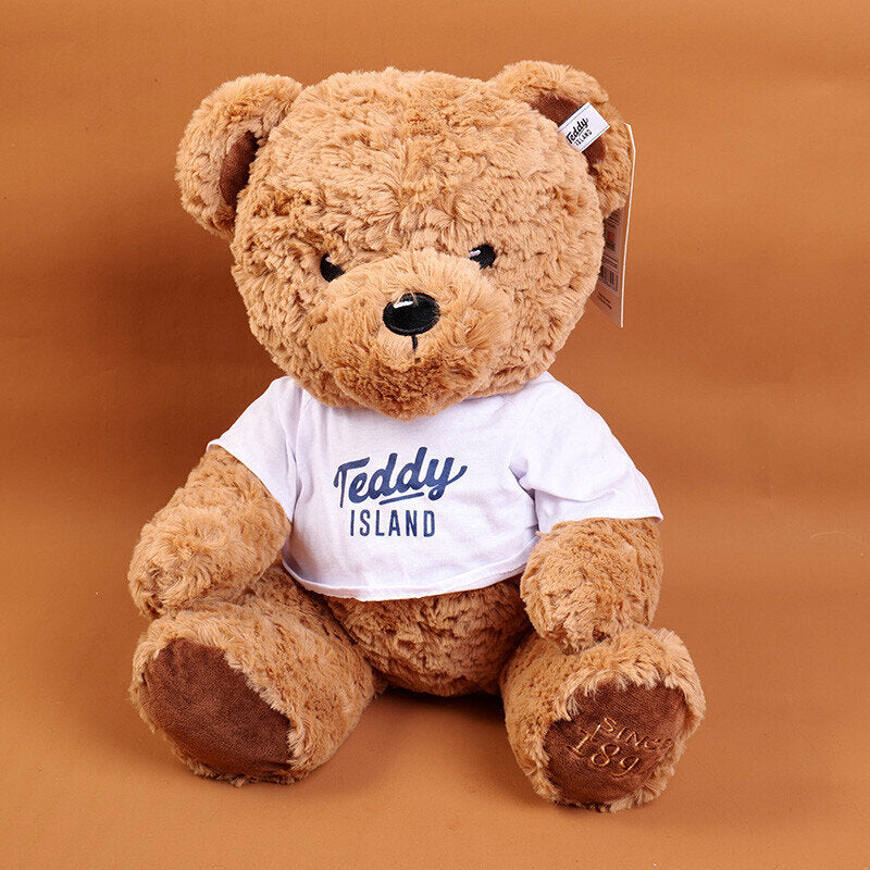TEDDY ISLAND bambola di peluche orsetto seduto di colore scuro con maglietta blu-35 cm