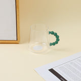Tazza in vetro con manico in perline